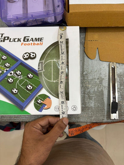 Measuring the dimensions of the catapult board game for kids featuring football-themed gameplay