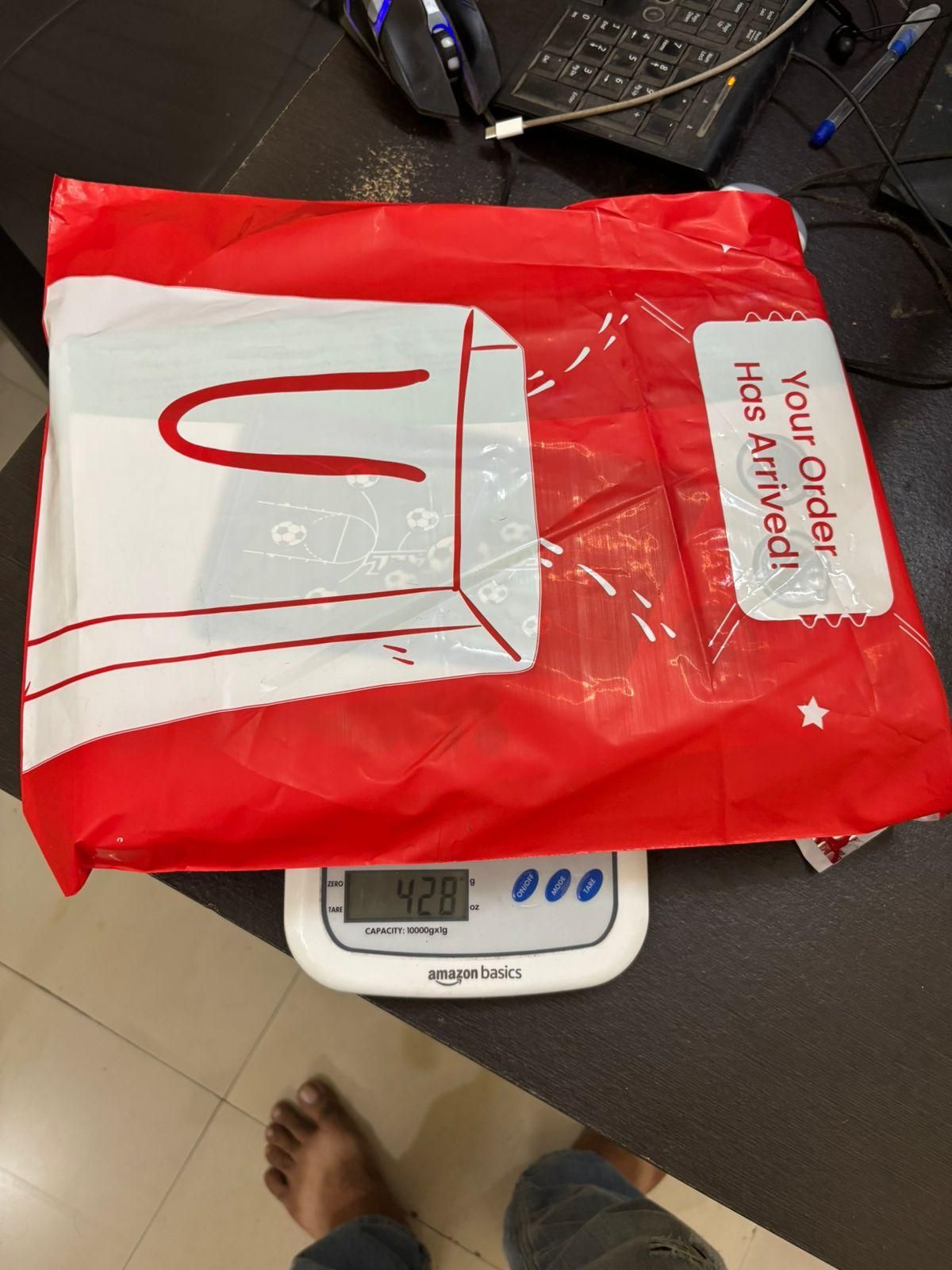 Red package containing the catapult board game for kids, ready for delivery and enjoyment