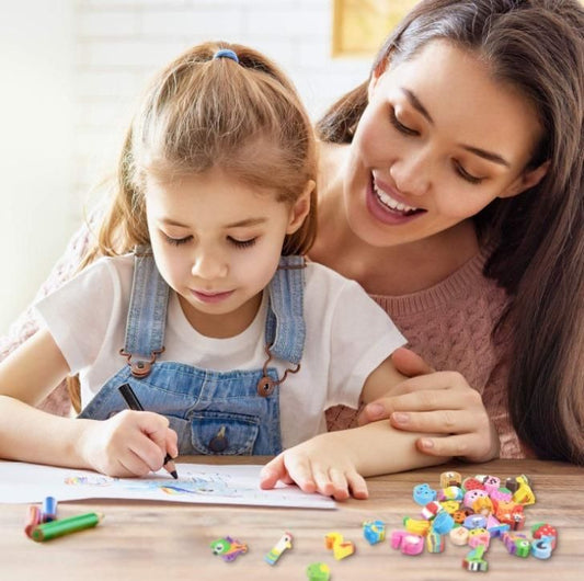 Mother assisting young girl with drawing and coloring activity, surrounded by colorful art supplies