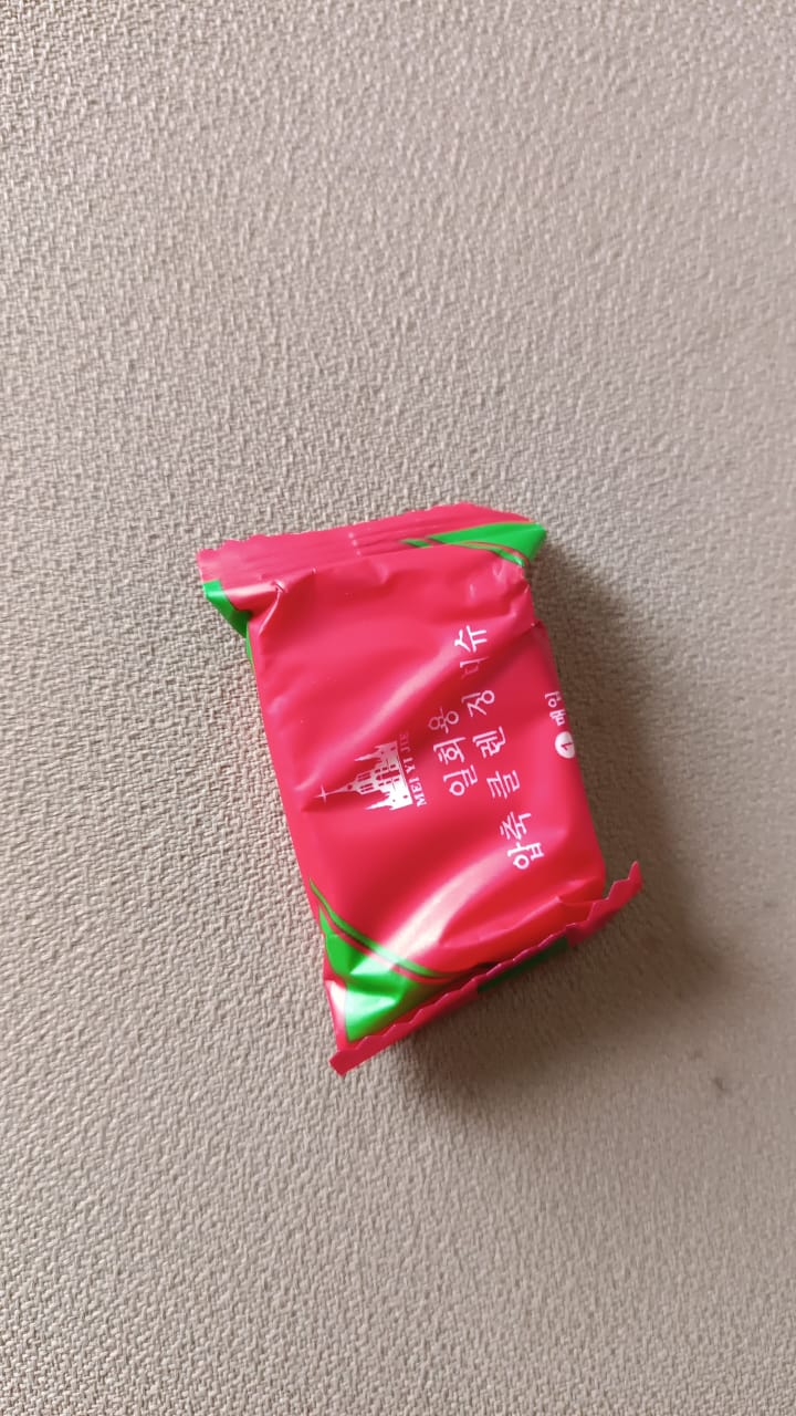 Compressed cotton towels for travel packed in bright pink and green packaging for easy portability