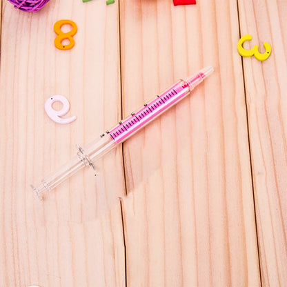 Creative fluorescent highlighter pen in pink surrounded by colorful educational letters on a wooden surface