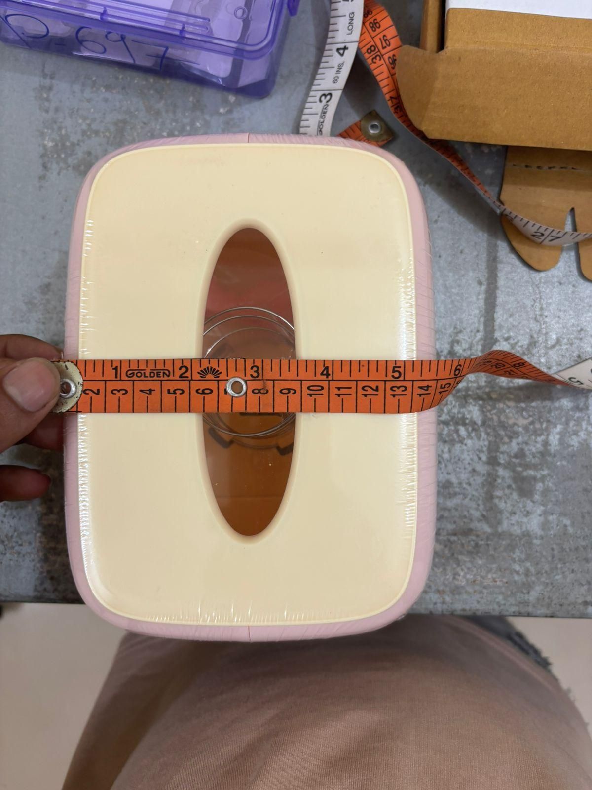 Creative square tissue box holder with an elegant design and measuring tape for size reference