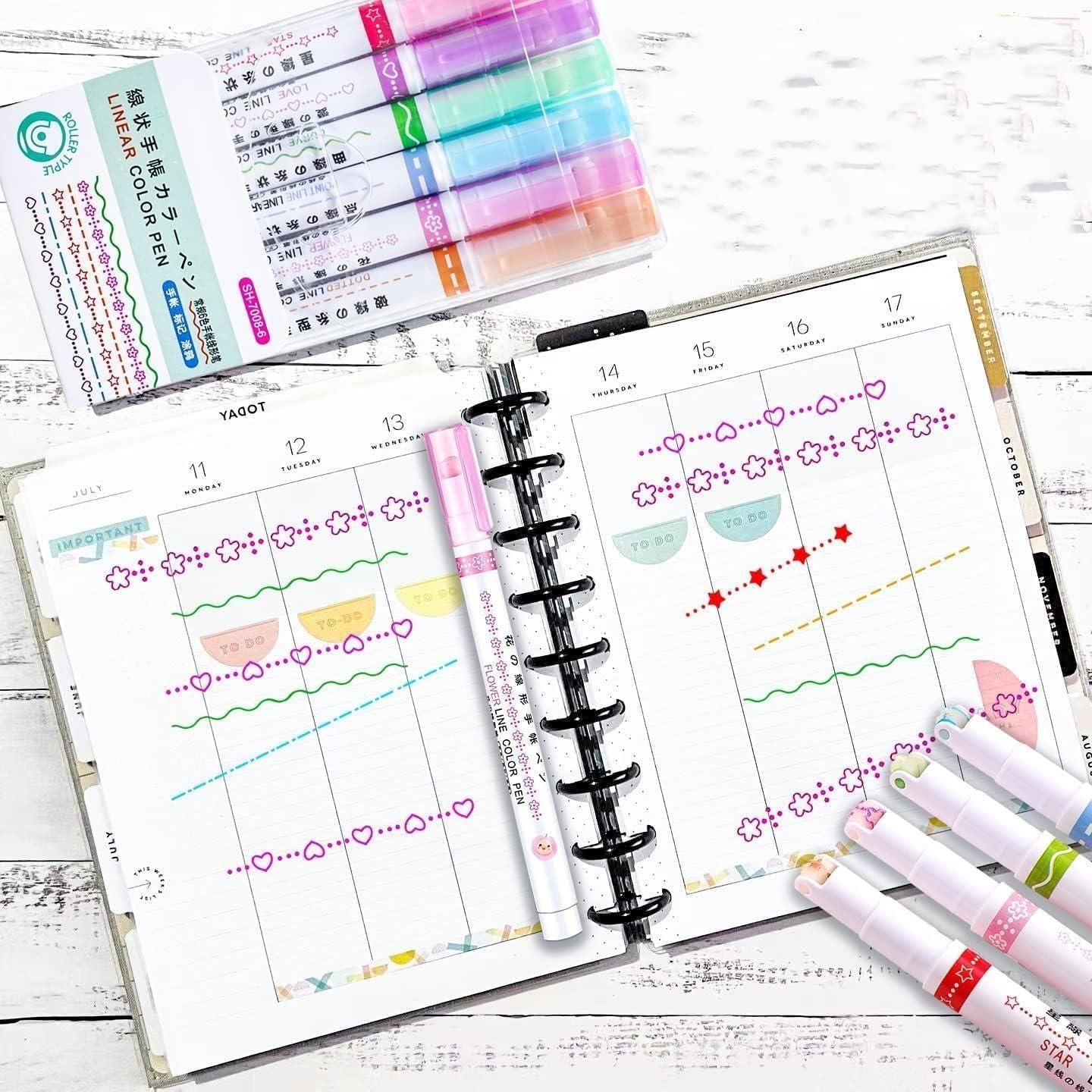 Colorful curve shape highlighter pens arranged above a planner with decorative monthly layout and colorful highlights