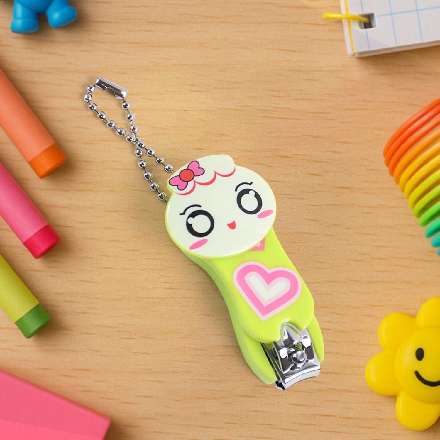 Cute cartoon nail clipper in green with a smiling face design and keychain for easy carrying