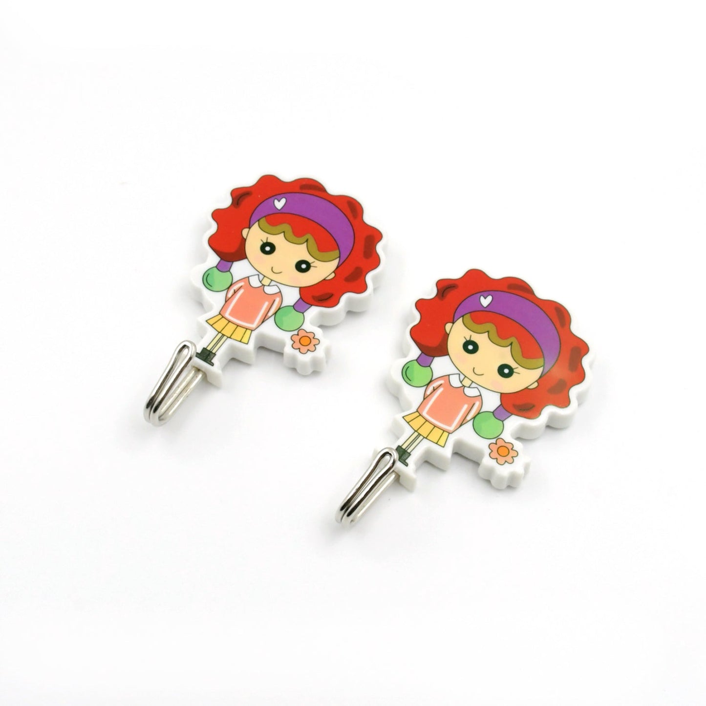 Cute cartoon wall hooks for kids featuring a smiling girl design with colorful hair and flowers