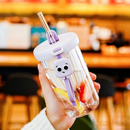 THE GIR FARMER glass smoothie tumbler with lid featuring a purple lock and clear straw held in hand with fruit inside