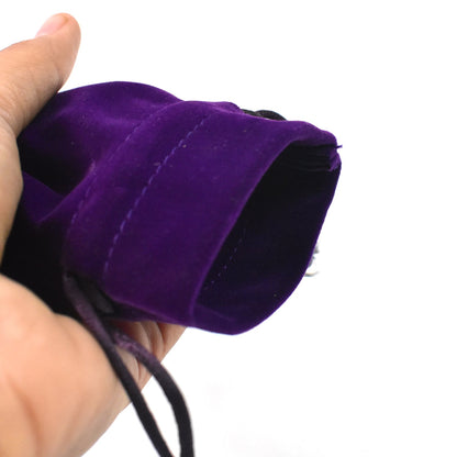 Hand holding a small purple velvet pouch ideal for small fancy return gift bags