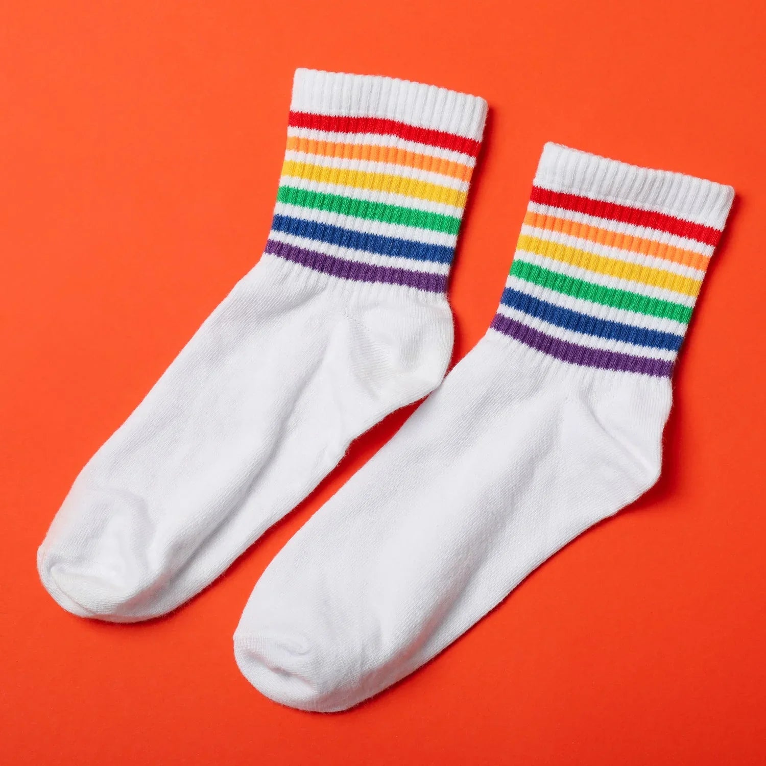 White designer socks for women featuring colorful rainbow stripes at the top