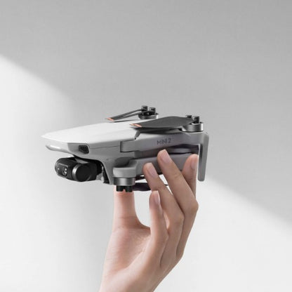DJI Mini 2 SE Drone held in hand, showcasing its compact design and advanced features