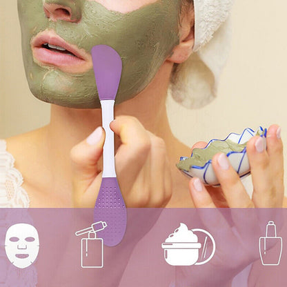 Double-headed silicone mask brush in use, applying green mask on a woman's face for skincare