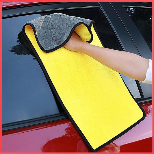 Person using double sided automotive cleaning towels on car window for effective drying