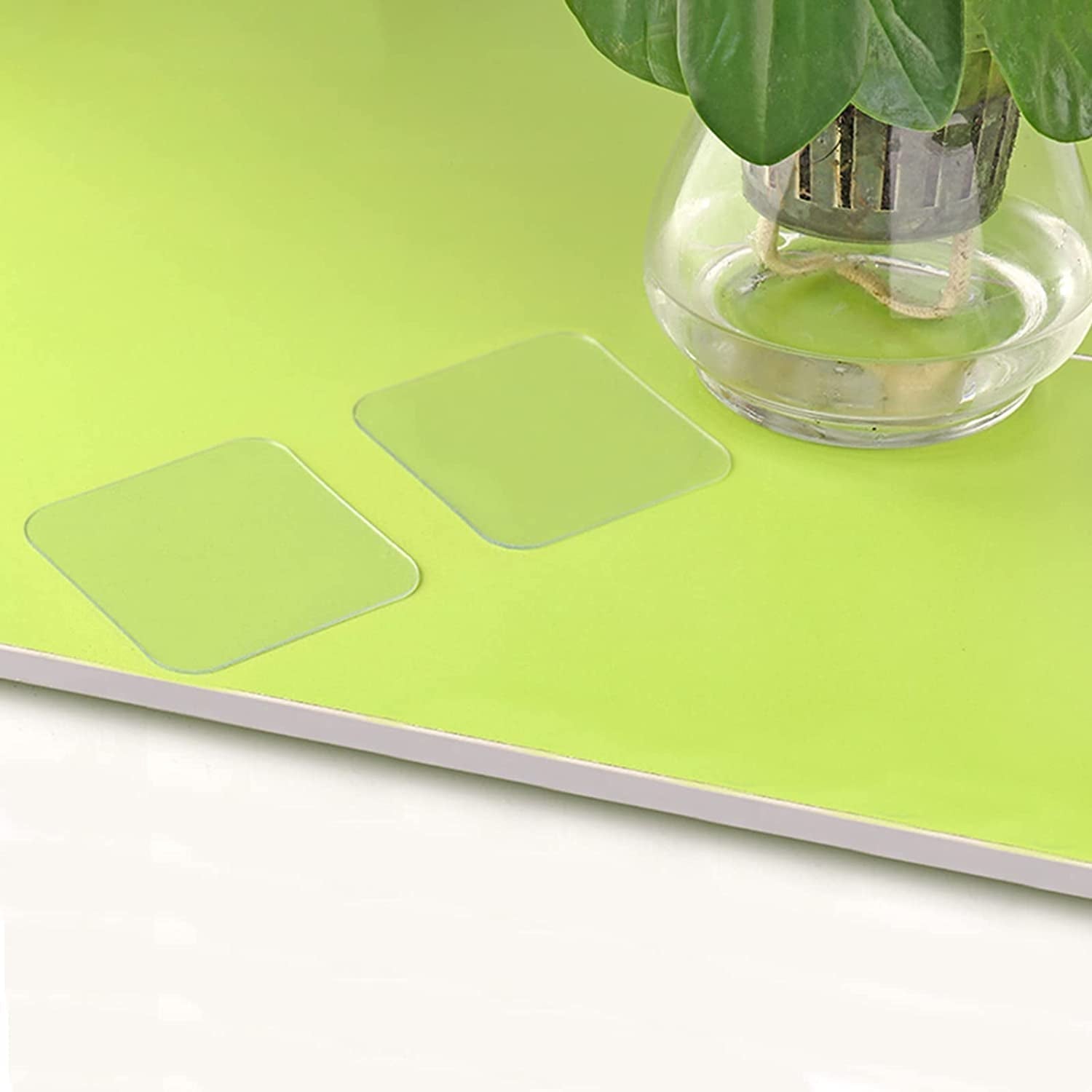 Double-sided nano adhesive tape on a bright green surface, ideal for various mounting needs