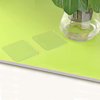 Double-sided nano adhesive tape on a bright green surface, ideal for various mounting needs