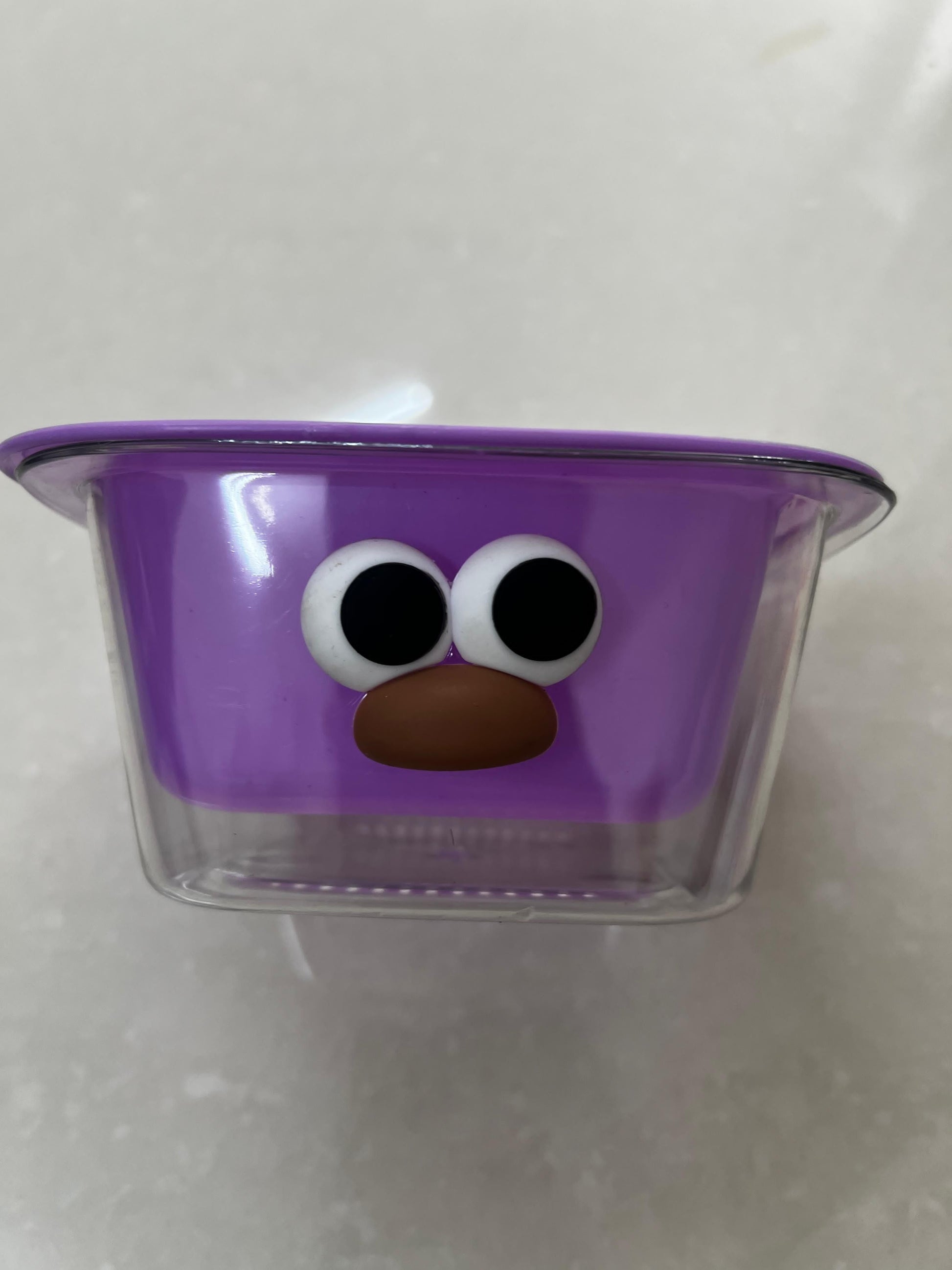 THE GIR FARMER dual layer fruit and veggie strainer in purple with a playful face design