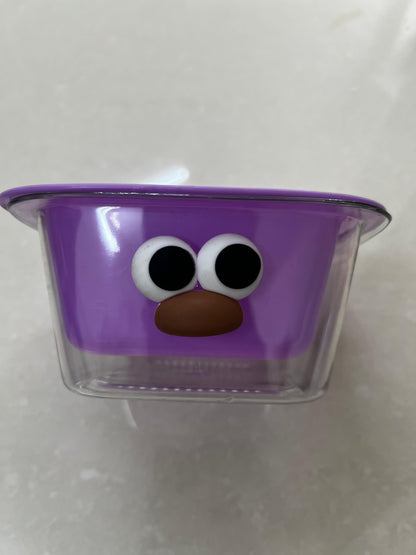 THE GIR FARMER dual layer fruit and veggie strainer in purple with a playful face design