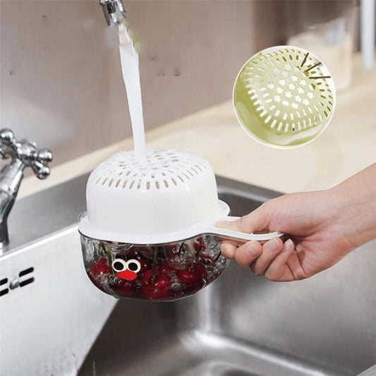 THE GIR FARMER dual layer fruit and veggie strainer in use rinsing strawberries over kitchen sink