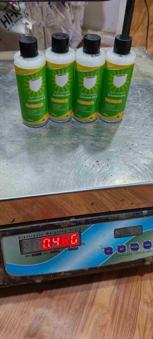 THE GIR FARMER organic multifunctional cleaner four green labeled bottles with black caps on a digital scale