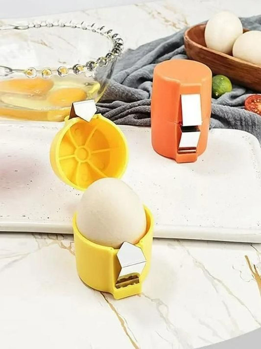 Yellow and orange egg topper cutter tool with egg on marble countertop beside bowl of cracked eggs