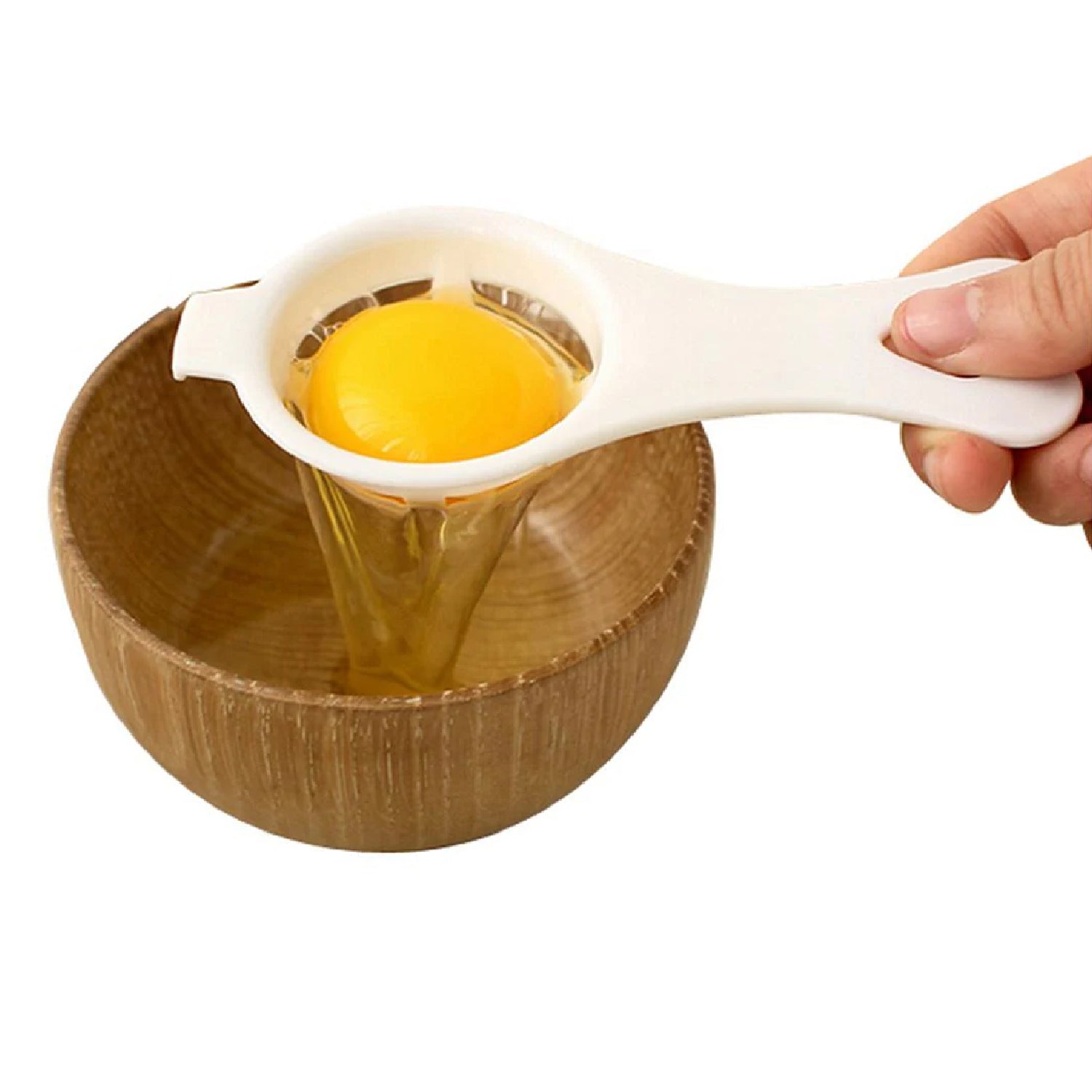 Your Brand egg yolk separator in use, separating yolk from egg white into a wooden bowl