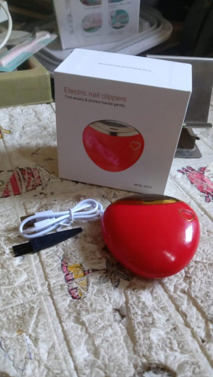 Red electric nail clipper with packaging and charging cable for easy nail care at home