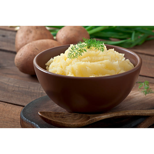 Creamy mashed potatoes in brown bowl prepared with Pure A2 Gir Cow Ghee with fresh dill garnish and potatoes