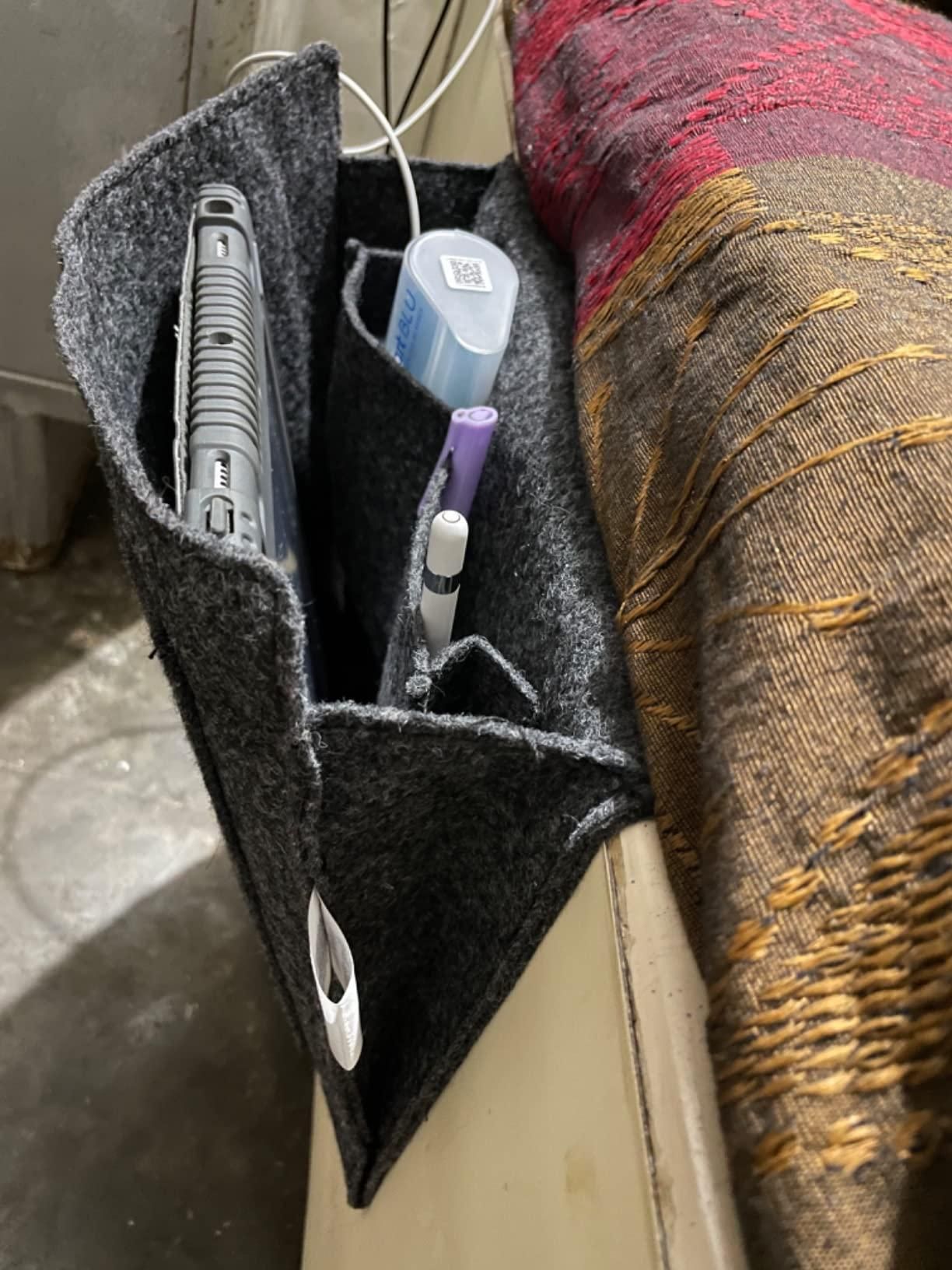 The Gir Farmer felt bedside pocket for essentials holding a remote, pens, and other small items next to a bed