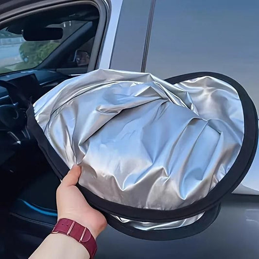 Folding car window sunshade being held up, ideal for blocking sunlight and keeping car interiors cool