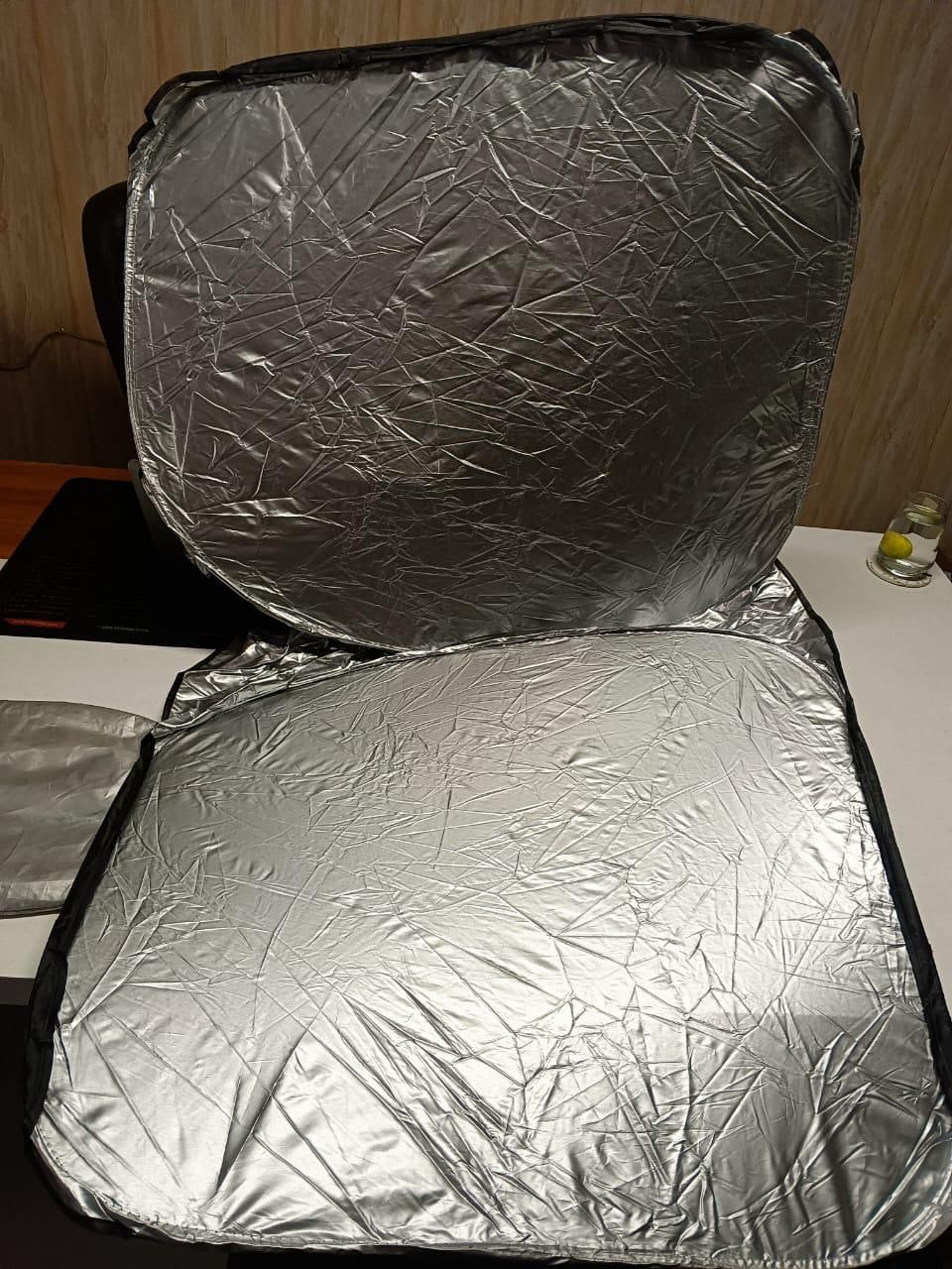 Folding car window sunshade in silver color designed to block harmful UV rays