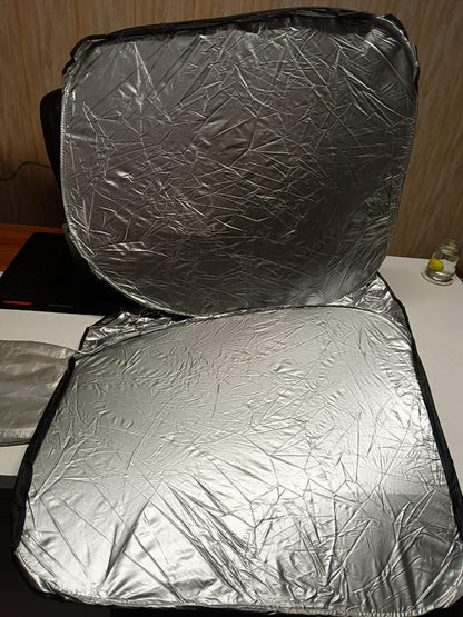 Folding car window sunshade in silver color designed to block harmful UV rays