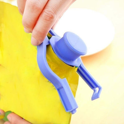 Hand using a purple food bag clip seal to securely close a yellow food storage bag