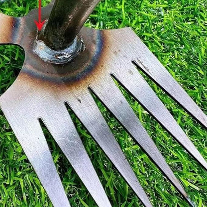 Close-up of metal tines on multi function shovel for home gardens with welded handle base on green grass