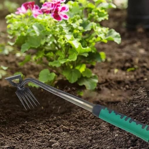 THE GIR FARMER multi function shovel for home gardens with green handle and forked end in soil