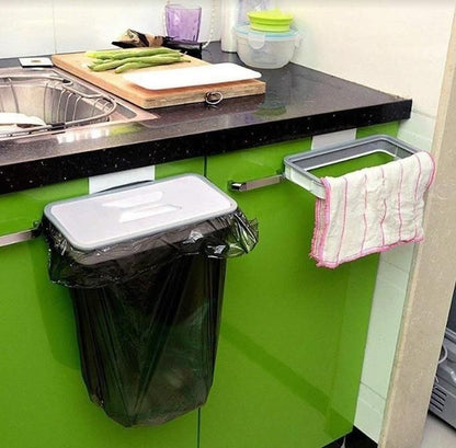 Attachable kitchen garbage bag holder with black trash bag mounted on green kitchen cabinet door