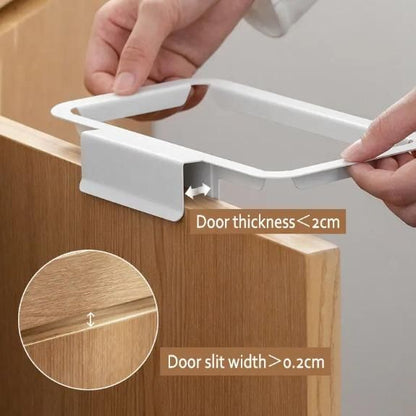 White attachable kitchen garbage bag holder being installed on a wooden cabinet door under 2cm thick