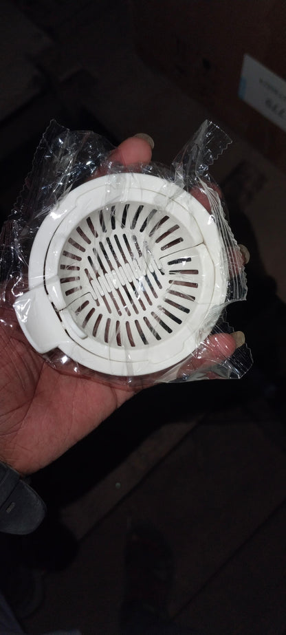 The Gir Farmer white plastic sink strainer for food particles in hand sealed in clear packaging