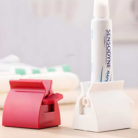 Toothpaste tube squeezer pack of 2 in red and white by The Gir Farmer holding toothpaste tubes