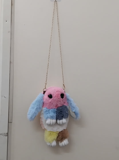 Girls bunny shaped sling bag with chain in pastel colors by THE GIR FARMER hanging on white wall