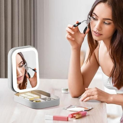 THE GIR FARMER lighted makeup mirror with storage tray woman using eyelash curler at vanity