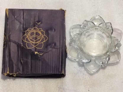 THE GIR FARMER glass lotus tea light holder made of clear glass with lotus petal design next to its decorative box