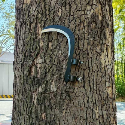 Grass sickle cutter head attached to a tree for convenient storage and easy access
