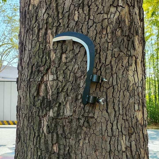 Grass sickle cutter head attached to a tree for convenient storage and easy access