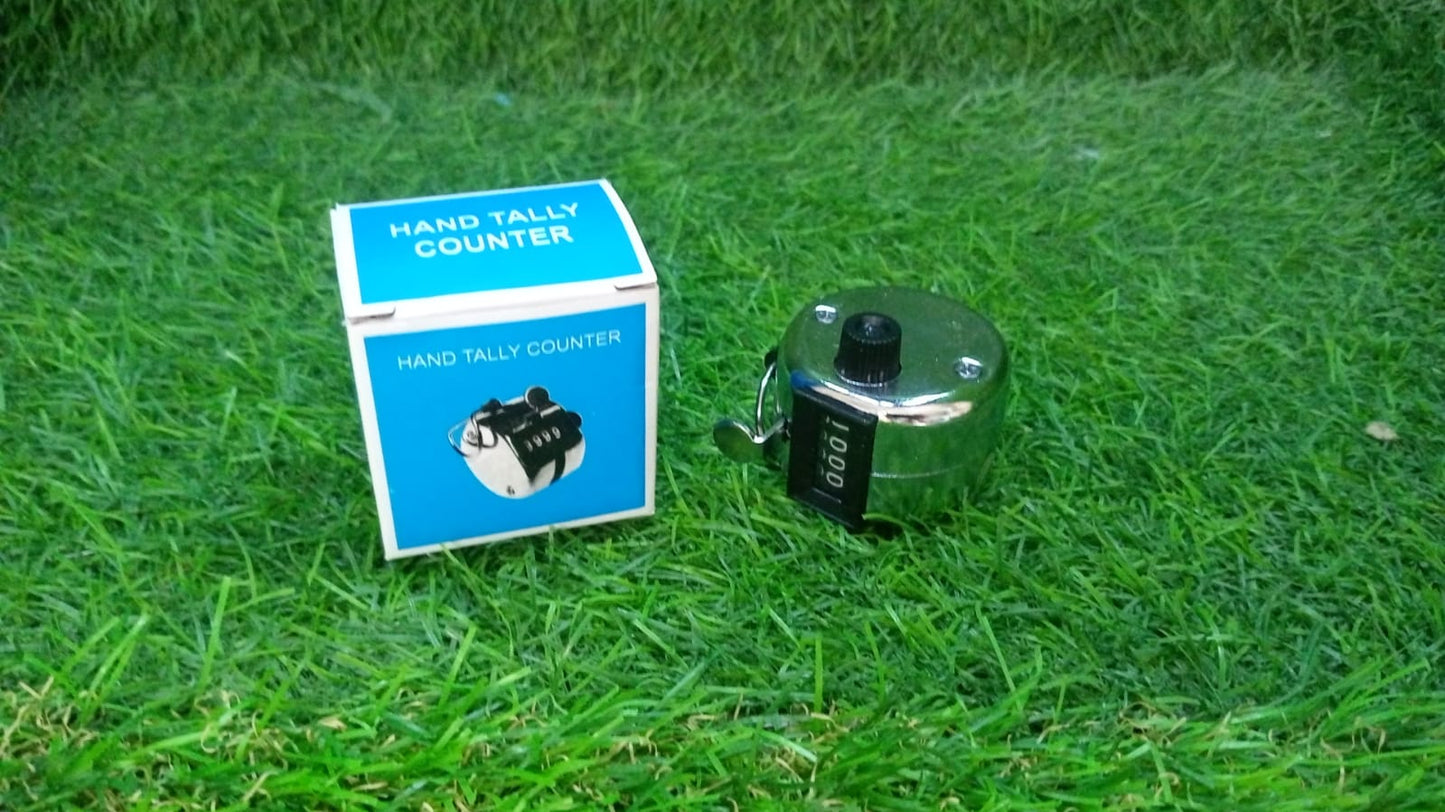 Your Brand handheld tally counter with chrome finish beside its blue box on green grass