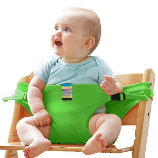 Bright green high chair safety seat for babies, securely holding a happy infant in a wooden high chair