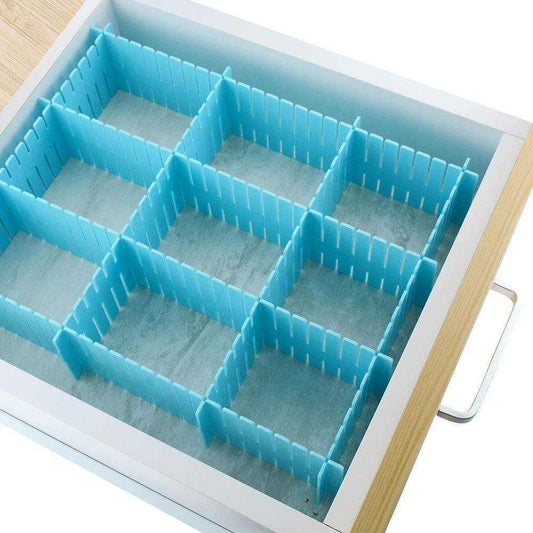 Blue adjustable drawer organizer dividers forming a 3x3 grid in a wood drawer with fabric liner and metal handle