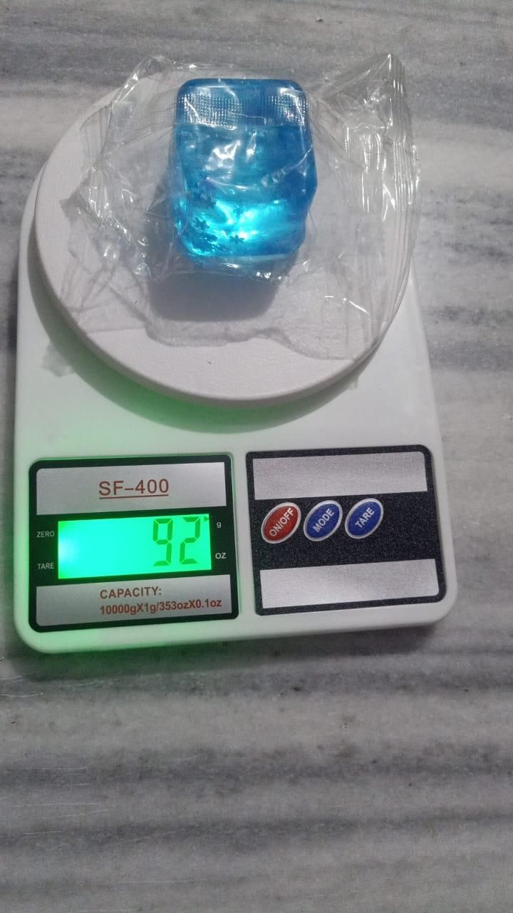 Blue ice cube stress ball on a digital scale displaying weight for stress relief and relaxation