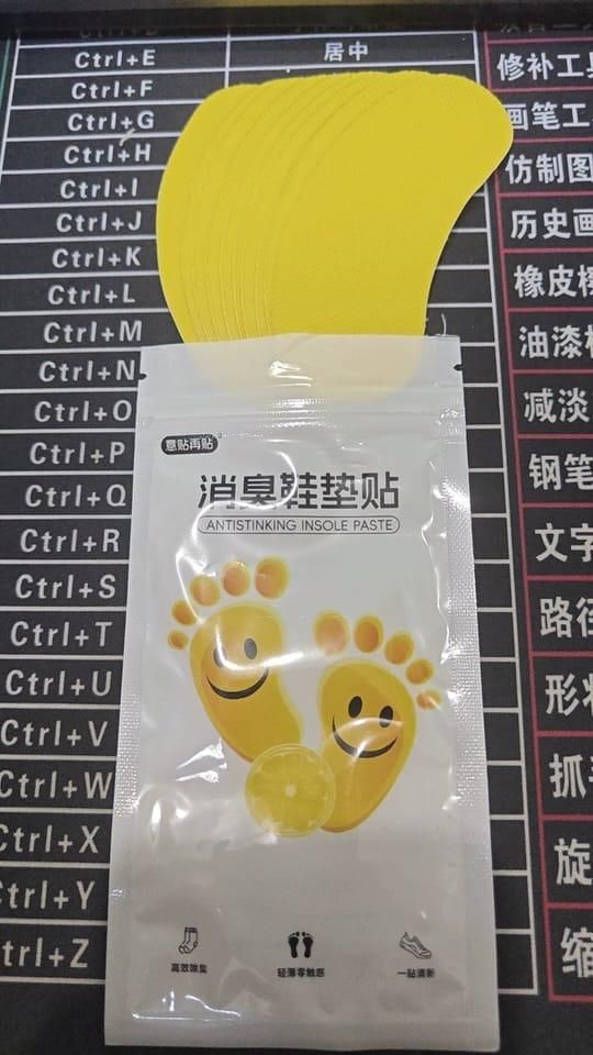 Yellow shoe deodorant patch pack with smiling foot design for odor control in footwear