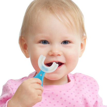 Happy toddler using a kids u shaped toothbrush for easy and effective teeth cleaning