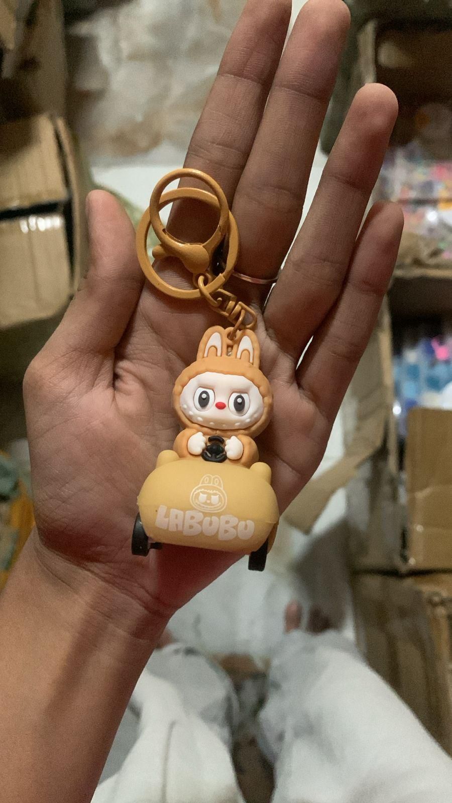 Cute Labubu car keychain featuring a playful character in a small yellow car
