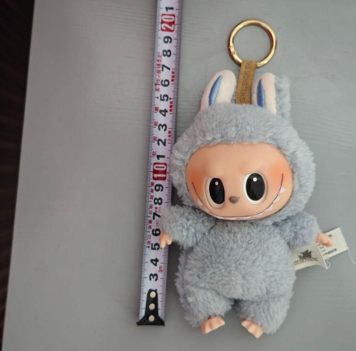 Labubu plush doll by THE GIR FARMER in gray bunny costume with keychain and measuring tape