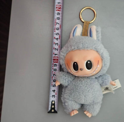 Labubu plush doll by THE GIR FARMER in gray bunny costume with keychain and measuring tape